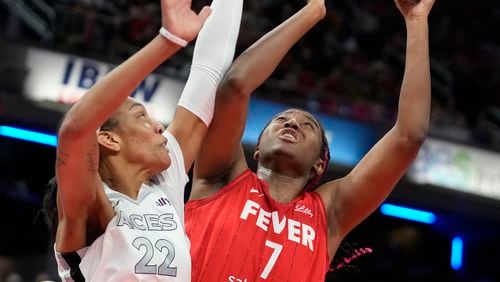 Indiana Fever's Aliyah Boston (7) shoots over Las Vegas Aces' A'ja Wilson (22) during the first half of a WNBA basketball game, Wednesday, Sept. 11, 2024, in Indianapolis. (AP Photo/Darron Cummings)