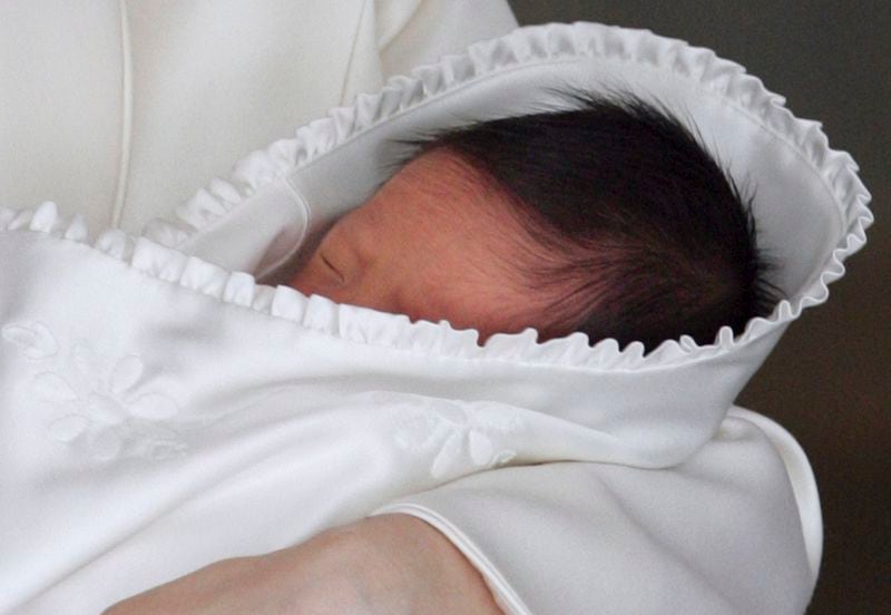 FILE - Japan's newborn Prince Hisahito sleeps in the arms of his mother Crown Princess Kiko as he leaves a Tokyo hospital Sept. 15, 2006. (AP Photo/Itsuo Inouye, Pool, File)