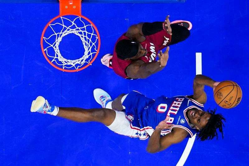FILE - Philadelphia 76ers' Tyrese Maxey (0) goes up to shoot against Miami Heat's Bam Adebayo, top, during the first half of an NBA basketball game, Monday, March 18, 2024, in Philadelphia. Paul George and the Philadelphia 76ers have agreed to a four-year, $212 million free-agent deal, a person with knowledge of the deal said Monday. Maxey is sticking around for the long haul, too — agreeing in principle to a five-year, $204 million extension with the Sixers on Monday, July 1, 2024, a person with knowledge of the deal told the AP, speaking on condition of anonymity because the deal was not yet finalized. (AP Photo/Matt Rourke, File)