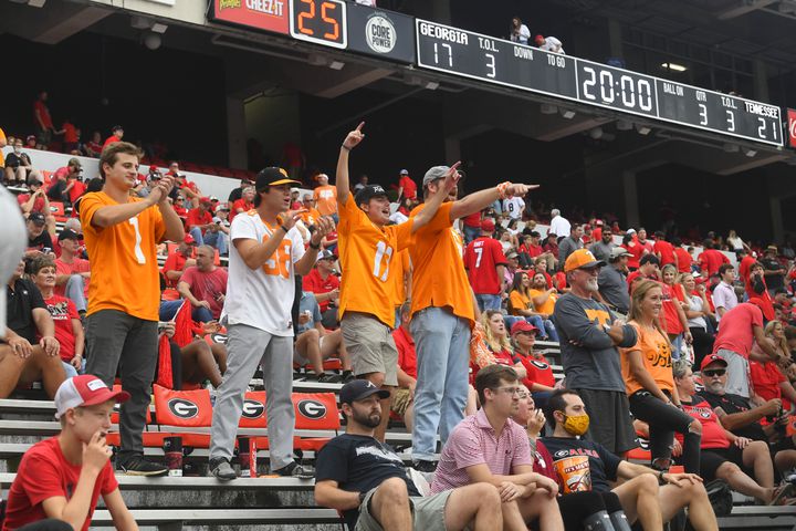 Georgia fans sit quietly as Tennessee fans cheer at the end of the first half as the scoreboard behind then reflects the score with Georgia behind by 3 points in a football game Saturday, Oct. 10, 2020, at Sanford Stadium in Athens. JOHN AMIS FOR THE ATLANTA JOURNAL- CONSTITUTION