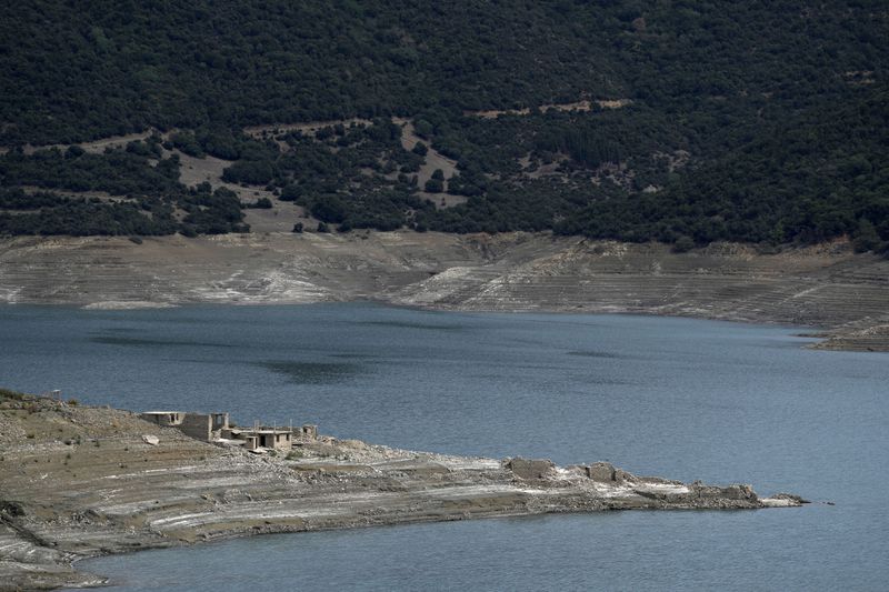 Buildings are seen in the sunken Kallio village that's resurfaced from the artificial Mornos Lake, some 200 kilometers (125 miles) northwest from Athens, central Greece, on Thursday, Sept. 5, 2024. (AP Photo/Thanassis Stavrakis)