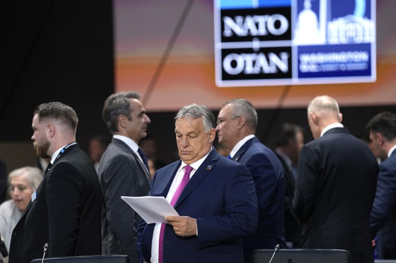 Prime Minister of Hungary Viktor Orban looks over notes during Working Session III of the NATO Summit in Washington, Thursday, July 11, 2024. (AP Photo/Susan Walsh)