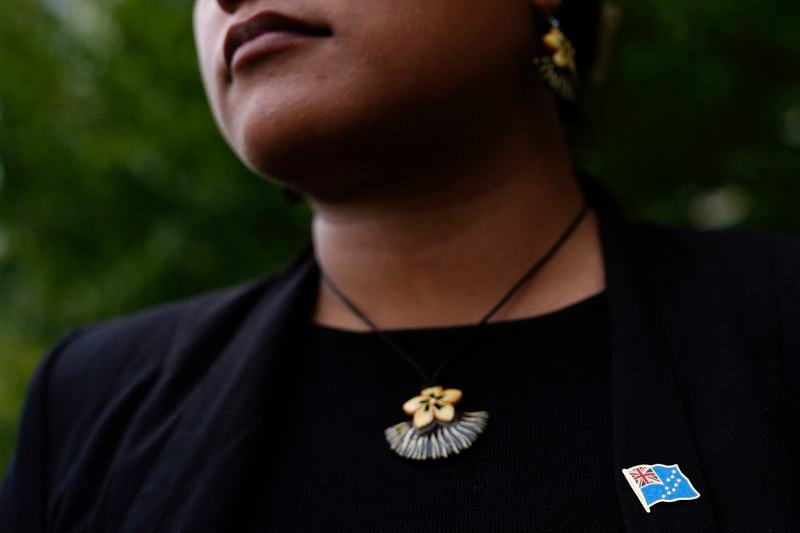 Grace Malie wears a pin of the Tuvalu flag while posing for photos, Monday, Sept. 23, 2024, at the United Nations headquarters. (AP Photo/Julia Demaree Nikhinson)