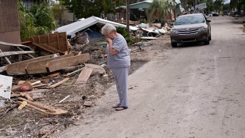 Elsie Hicks looks at the destruction of the home she has loved in for 25 years, in the aftermath of Hurricane Helene, in Horseshoe Beach, Fla., Saturday, Sept. 28, 2024. (AP Photo/Gerald Herbert)