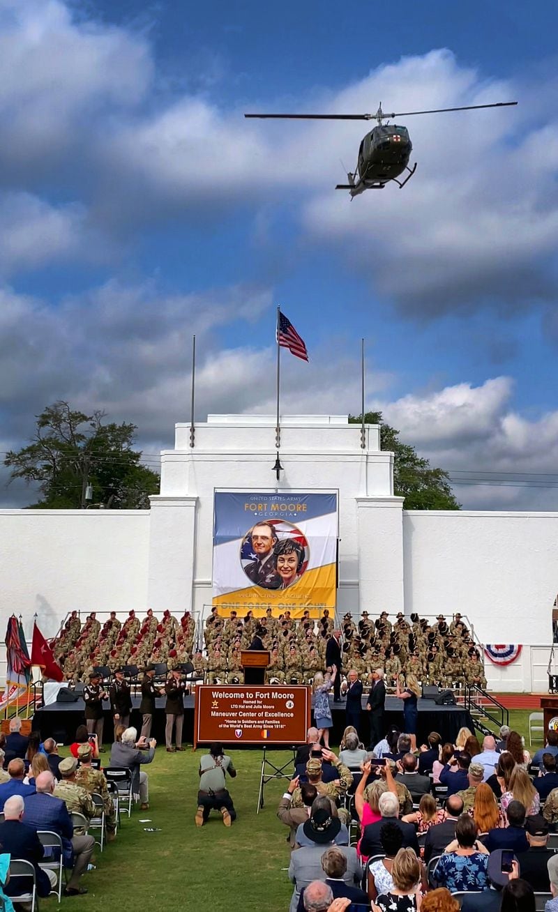 A Bell UH-1 helicopter, commonly known as a "Huey," flies over Doughboy Stadium after the new Fort Moore sign was unveiled Thursday morning. Fort Benning was redesignated as Fort Moore during the ceremony. (Photo Courtesy of Mike Haskey/The Ledger-Enquirer)