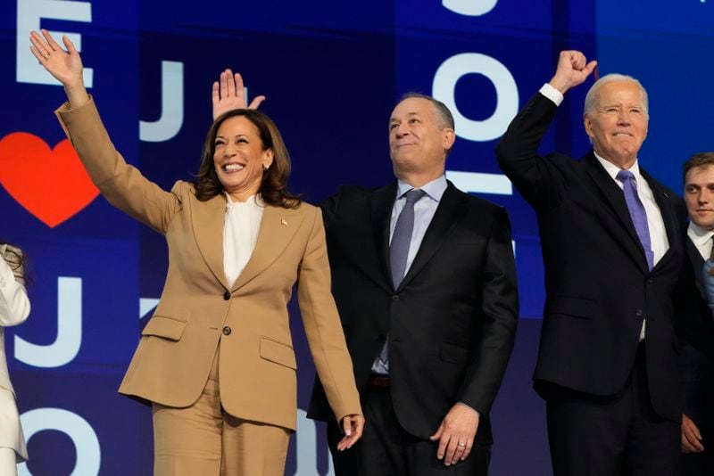 President Joe Biden waves with Democratic presidential nominee Vice President Kamala Harris and second gentleman Doug Emhoff during the first day of Democratic National Convention, Monday, Aug. 19, 2024, in Chicago. (AP Photo/Jacquelyn Martin)