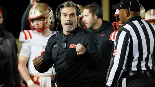 Rome head coach John Reid talks with an official during their game against Langston Hughes in the Class 6A semi-final at Lakewood Stadium, Friday, December 2, 2022, in Atlanta. Jason Getz / Jason.Getz@ajc.com)
