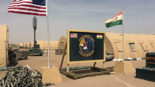 FILE- In this file photo taken Monday, April 16, 2018, a U.S. and Niger flag are raised side by side at the base camp for air forces and other personnel supporting the construction of Niger Air Base 201 in Agadez, Niger. The US handed over its last military base in Niger to the country's authorities, the US Department of Defense and Niger’s Ministry of Defense announced in a joint statement on Monday, Aug. 5, 2024. (AP Photo/Carley Petesch, File)