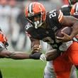 FILE - Cleveland Browns running back Nick Chubb (24) is pressured by Cincinnati Bengals safety Dax Hill, left, during an NFL football game, Sept. 10, 2023, in Cleveland. (AP Photo/Sue Ogrocki, File)