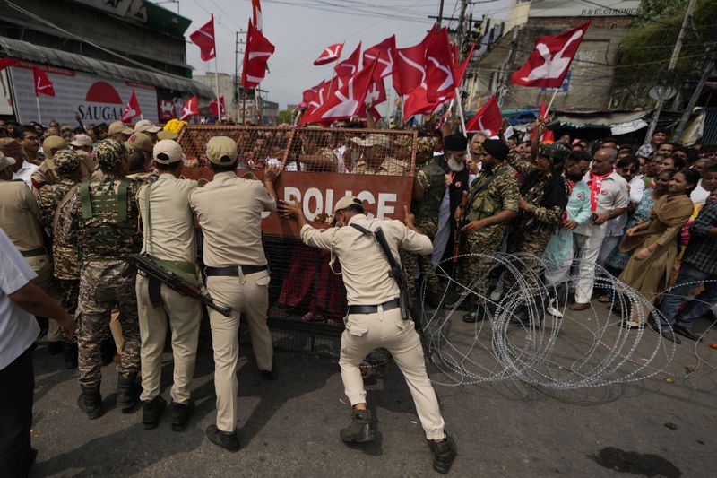 Policemen stop supporters of National Conference Party from accompanying their candidate during the filing of nomination papers for the upcoming Jammu and Kashmir Assembly elections in Jammu, India, Sept.10, 2024. (AP Photo/Channi Anand, File)