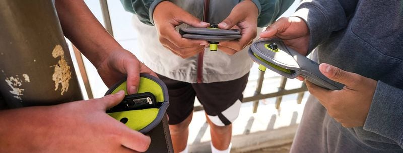 Students are placing their phones in Yondr pouches, which are designed to prevent students from accessing their devices during class. Schools in several Georgia districts will be testing the pouches this year. (Courtesy of Yondr)