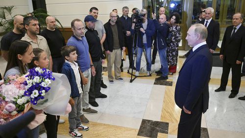 Russian President Vladimir Putin, right, speaks to released Russian prisoners upon their arrival at the Vnukovo government airport outside Moscow, Russia, on Thursday, Aug. 1, 2024. The United States and Russia have made their biggest prisoner swap in post-Soviet history. (Kirill Zykov, Sputnik, Kremlin Pool Photo via AP)