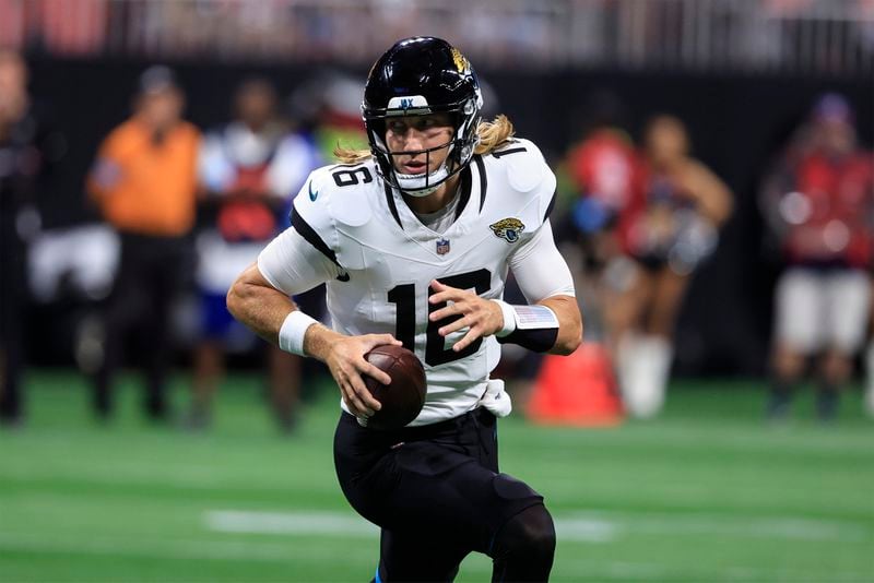 Jacksonville Jaguars quarterback Trevor Lawrence (16) runs out of the pocket against the Atlanta Falcons in the first half of an NFL preseason footballl game, Friday, Aug. 23, 2024, in Atlanta. (AP Photo/Butch Dill)