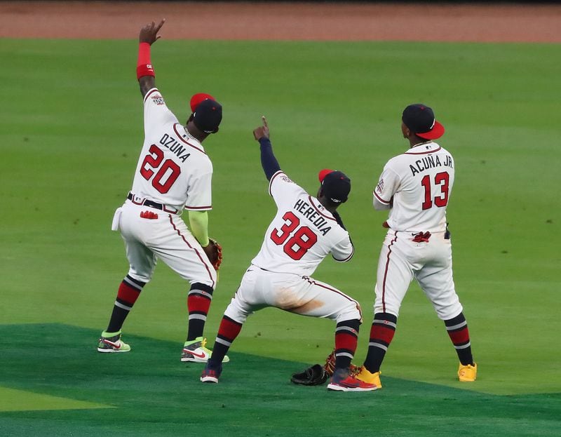 Braves outfielders Marcell Ozuna (from left), Guillermo Heredia, and Ronald Acuna pose for a selfie at the end of a 10-0 victory over the Chicago Cubs Wednesday, April 28, 2021, in Atlanta. (Curtis Compton / Curtis.Compton@ajc.com)