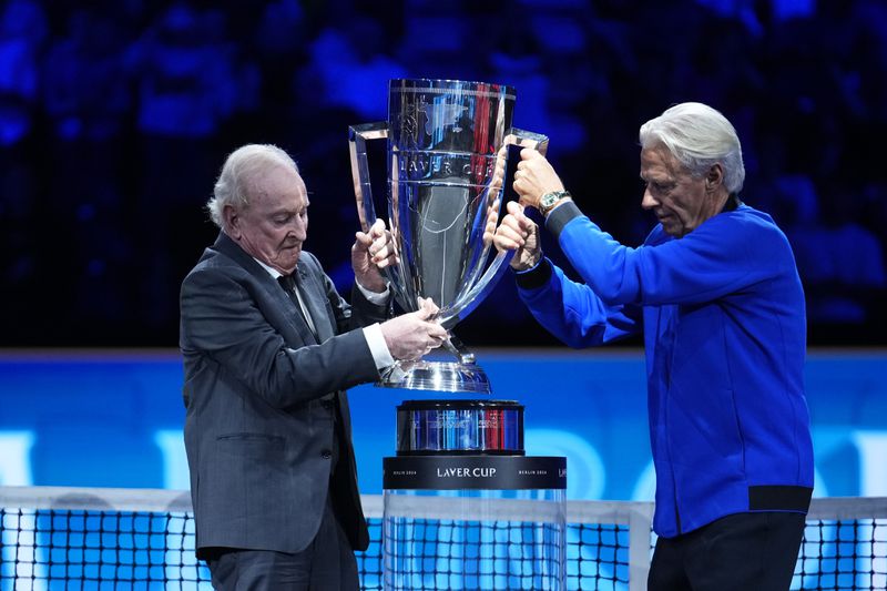 Team Europe's captain and Swedish former tennis player Bjorn Borg, right, and Australian former tennis player Rod Laver lift the trophy during the awarding ceremony at the end of the Laver Cup tennis tournament, Berlin, Germany, Sunday, Sept. 22, 2024. (AP Photo/Ebrahim Noroozi)