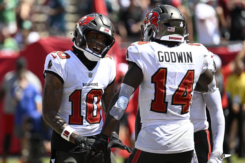 Tampa Bay Buccaneers' Trey Palmer celebrates with Chris Godwin after scoring a touchdown during the first half of an NFL football game against the Philadelphia Eagles, Sunday, Sept. 29, 2024, in Tampa, Fla. (AP Photo/Jason Behnken)