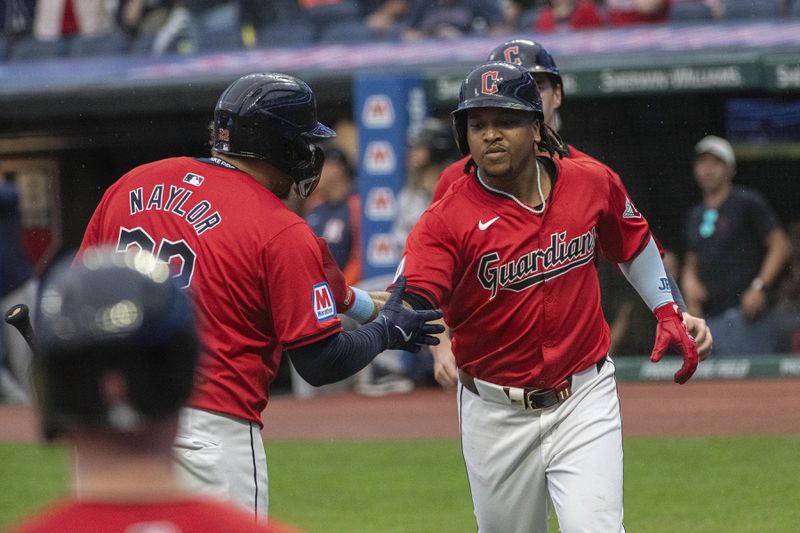 Cleveland Guardians' Josh Naylor, left, greets Jose Ramirez, right, after Ramirez hit a two-run home run off Houston Astros starting pitcher Justin Verlander during the first inning of a baseball game in Cleveland, Saturday, Sept. 28, 2024. (AP Photo/Phil Long)