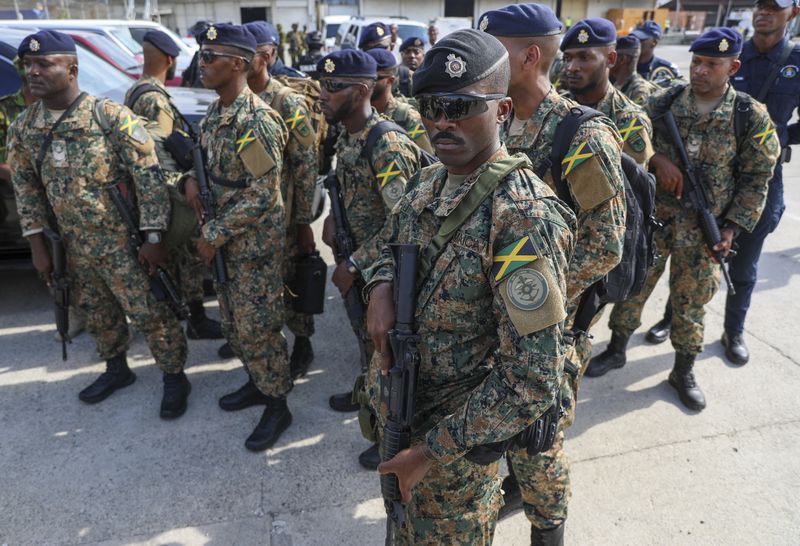 Police from Jamaica stand on the tarmac of the Toussaint Louverture International Airport after landing in Port-au-Prince, Haiti, Thursday, Sept. 12, 2024. (AP Photo/Odelyn Joseph)