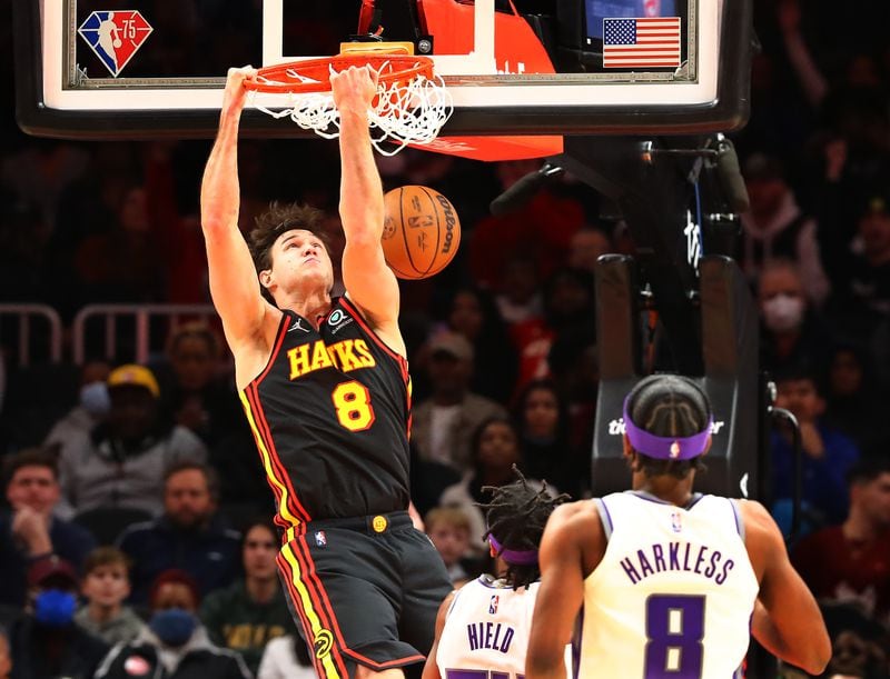 Hawks forward Danilo Gallinari goes in for a reverse slam against Sacramento Kings guard Buddy Hield during a 121-104 victory in a NBA basketball game on Wednesday, Jan. 26, 2022, in Atlanta.   “Curtis Compton / Curtis.Compton@ajc.com”`