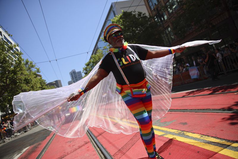 A reveler wears a rainbow-colored outfit during a Pride Parade, Sunday, June 30, 2024, in San Francisco. (AP Photo/Ethan Swope)