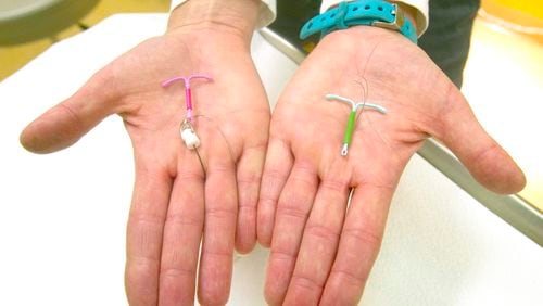 FILE - Dr. Susan Gorman displays the Skyla IUD, left, and the Mirena IUD, at High Lakes Gynecology in Redmond, Ore., Jan. 14, 2015. (Andy Tullis/The Bulletin via AP)