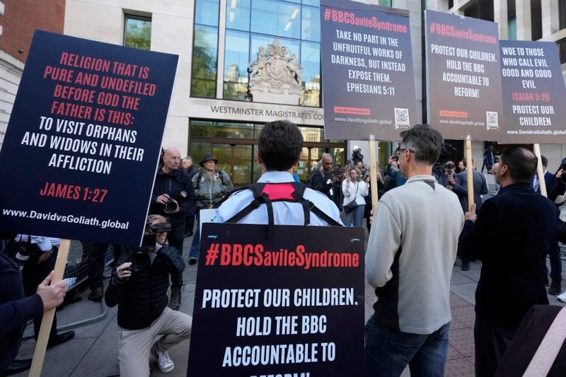 A small number of protesters wait for Huw Edwards an ex-BBC news presenter to arrive at Westminster Magistrate's Court for sentencing after he pleaded guilty to three counts of making indecent images of children in London, Monday, Sept. 16, 2024. (AP Photo/Frank Augstein)