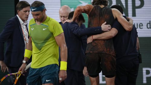 FILE - Germany's Alexander Zverev is carried off the court after twisting his ankle during the semifinal match against Spain's Rafael Nadal, left, at the French Open tennis tournament in Roland Garros stadium in Paris, France, Friday, June 3, 2022. Rafael Nadal is in the French Open field, after all, and the 14-time champion was set up for a challenging first-round matchup in Thursday’s draw against Alexander Zverev. (AP Photo/Christophe Ena)