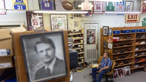 Lane Teilhaber, a seller for Friedman’s Shoes, sits in the store in Atlanta on Wednesday, July 31, 2024. (Arvin Temkar / AJC)