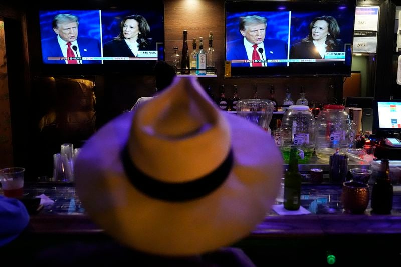 Charles Hudson, 76, from Chicago watches the presidential debate between Republican presidential nominee former President Donald Trump and Democratic presidential nominee Vice President Kamala Harris at the Knotty Luxe Bistro Tuesday, Sept. 10, 2024, in Markham, Ill. (AP Photo/Charles Rex Arbogast)