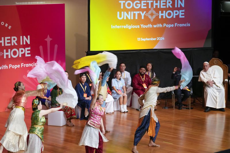 Pope Francis, right, attends an interreligious meeting with young people at the Catholic Junior College in Singapore, Friday, Sept. 13, 2024. Pope Francis is wrapping up his visit to Singapore by praising its tradition of interfaith harmony. (AP Photo/Gregorio Borgia)