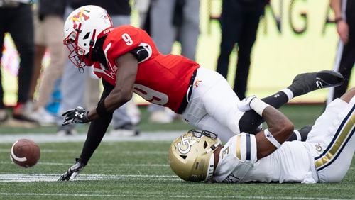 Virginia Military Institute wide receiver Julio DaSilva (9) fumbles after being hit by Georgia Tech defensive back Ahmari Harvey (3) during the first half of a NCAA college football game Sunday, Sept. 14, 2024, in Atlanta,. (AP Photo/John Bazemore)