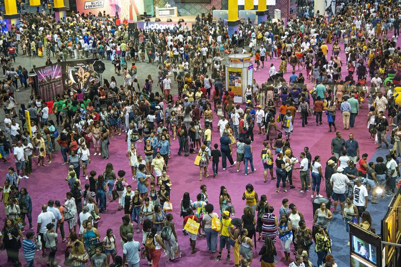 FILE - Attendees walk around the 2018 Essence Festival at the Ernest N. Morial Convention Center, July 6, 2018, in New Orleans. New Orleans officially opened its arms in welcome Thursday, July 4, 2024, to the thousands of people descending on the Big Easy for the 30th annual celebration of the Essence Festival of Culture. (Photo by Amy Harris/Invision/AP, File)