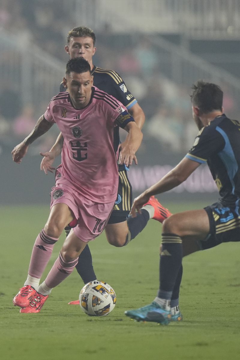 Philadelphia Union midfielders Jack McGlynn (16) and Leon Flach (31) defend Inter Miami forward Lionel Messi (10) during the first half of an MLS soccer match, Saturday, Sept. 14, 2024, in Fort Lauderdale, Fla. (AP Photo/Marta Lavandier)