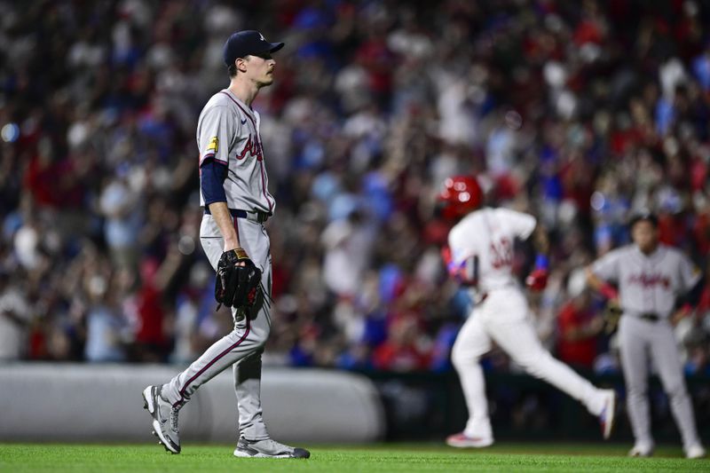 Atlanta Braves' Max Fried, left, walks off the mound after giving up a solo home run to Philadelphia Phillies' Edmundo Sosa during the third inning of a baseball game, Saturday, Aug. 31, 2024, in Philadelphia. (AP Photo/Derik Hamilton)