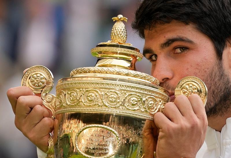 FILE - Spain's Carlos Alcaraz celebrates with the trophy after beating Serbia's Novak Djokovic to win the final of the men's singles at the Wimbledon tennis championships in London, Sunday, July 16, 2023. (AP Photo/Kirsty Wigglesworth, File)