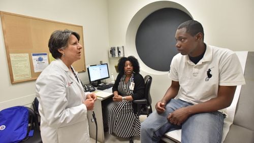 April 17, 2019 Atlanta - Dr. Claudia Vellozzi (left), medical director of Chronic Care Clinic, and Karen Sutton (center), Licensed Clinical Social Worker (LCSW), talk to Alex Harris, who is a Chronic Care Clinic program participant, at Grady Memorial Hospital's Chronic Care Clinic in Atlanta on Wednesday, April 17, 2019. The Chronic Care Clinic is unique in that it's got not just a doctor and a nurse and assistants, but community health workers who get deeply involved in the patient's situation, a social worker who hooks them up with resources, a behavioral health clinician who addresses addiction and mental health issues, and a highly credentialed pharmacist. HYOSUB SHIN / HSHIN@AJC.COM
