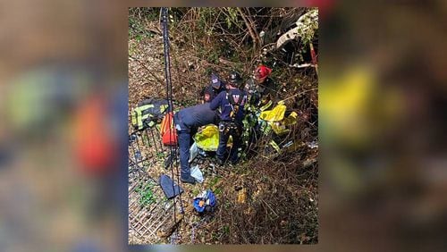 A driver was trapped in their vehicle after falling 40 feet into a ravine in Sandy Springs on Wednesday night. (Credit: Sandy Springs Fire Department)