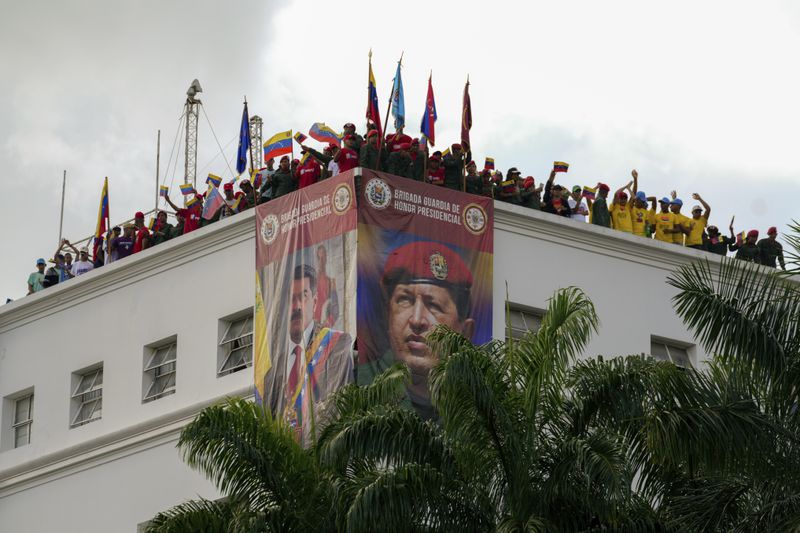 Members of the presidential guard listen to Venezuela's President Nicolas Maduro addressing government loyalists gathered at the presidential palace in support of his reelection one month after the presidential vote, in Caracas, Venezuela, Wednesday, Aug. 28, 2024. (AP Photo/Ariana Cubillos)