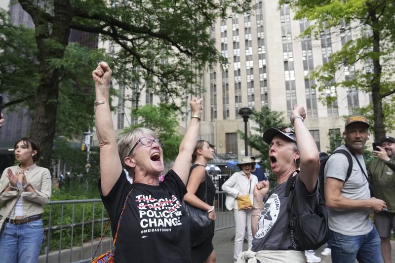 
                        People react to former President Donald Trump being found guilty of all counts in his criminal trial outside the Manhattan Criminal Courthouse in New York, on Thursday, May 30, 2024. Trump has been convicted of falsifying records to cover up a sex scandal that threatened his ascent to the White House in 2016, part of a scheme that prosecutors described as a fraud on the American people. He is the first American president to be declared a felon. (Todd Heisler/The New York Times)
                      