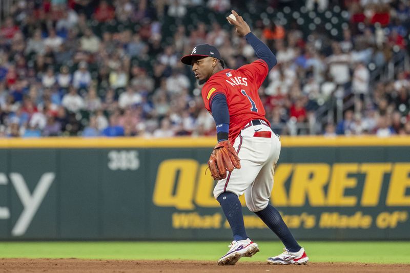 Atlanta Braves second baseman Ozzie Albies prepares to throw out Kansas City Royals' Tommy Pham at first base in the eighth inning of a baseball game, Friday, Sept. 27, 2024, in Atlanta. (AP Photo/Jason Allen)