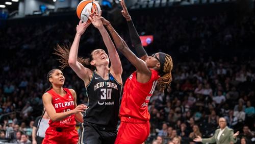 New York Liberty forward Breanna Stewart (30) is defended by Atlanta Dream guard Rhyne Howard (10) during the first half of a WNBA basketball first-round playoff game Sunday, Sept. 22, 2024, in New York. (AP Photo/Corey Sipkin)