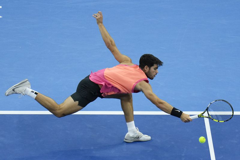 Carlos Alcaraz of Spain chases the ball from Jannik Sinner of Italy during their men's singles finals match of the China Open tennis tournament, at the National Tennis Center in Beijing, Wednesday, Oct. 2, 2024. (AP Photo/Andy Wong)