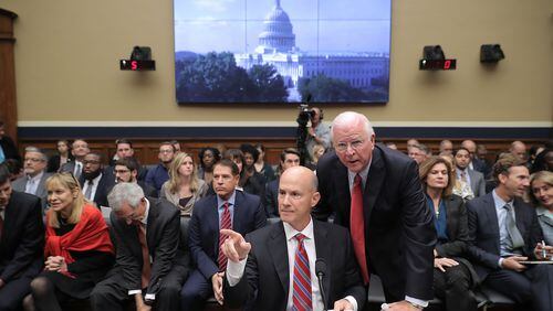 Former Republican Sen. Saxby Chambliss advises former Equifax CEO Richard Smith before he testifies to the House Energy and Commerce Committee on Oct. 3, 2017. (Photo by Chip Somodevilla/Getty Images)