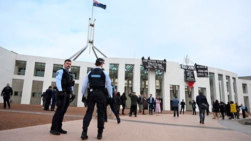 Pro-Palestinian protesters hang banners from the top of Parliament House in Canberra, Australia, Thursday, July 4, 2024. Pro-Palestinian protesters breached security at Australia’s Parliament House to unfurl banners from the roof on Thursday as a senator quit the government over its direction on the Gaza war. (Lukas Coch/AAP Image via AP)