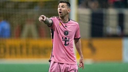 Inter Miami forward Lionel Messi talks to a teammate during the second half of a MLS soccer match against Atlanta United Wednesday, Sept. 18, 2024. (AP Photo/John Bazemore)