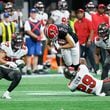 Atlanta Falcons wide receiver Drake London (5) gets tackled after a catch during overtime of an NFL football game against the Tampa Bay Buccaneers on Thursday, October 3, 2024, at Mercedes-Benz Stadium in Atlanta. 
(Miguel Martinez/ AJC)