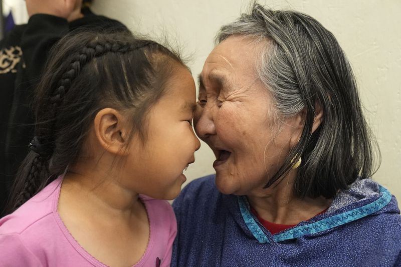 Girlie Carl, 4, plays with her grandmother Marie Carl, 75, on Thursday, Aug. 15, 2024, Mertarvik, Alaska. (AP Photo/Rick Bowmer)