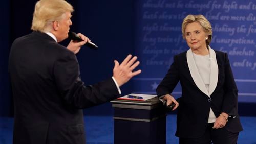 Democratic presidential nominee Hillary Rodham Clinton listens to Republican presidential nominee Donald Trump during the second presidential debate at Washington University in St. Louis on Sunday, Oct. 9, 2016.  (John Locher/AP)