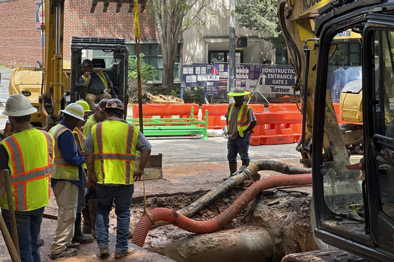 Workers try to fix a leaking water main junction on Monday, June 3, 2024, in Atlanta. Water pressure is returning to downtown Atlanta and nearby neighborhoods, after a water outage that began Friday. (AP Photo/Jeff Amy)
