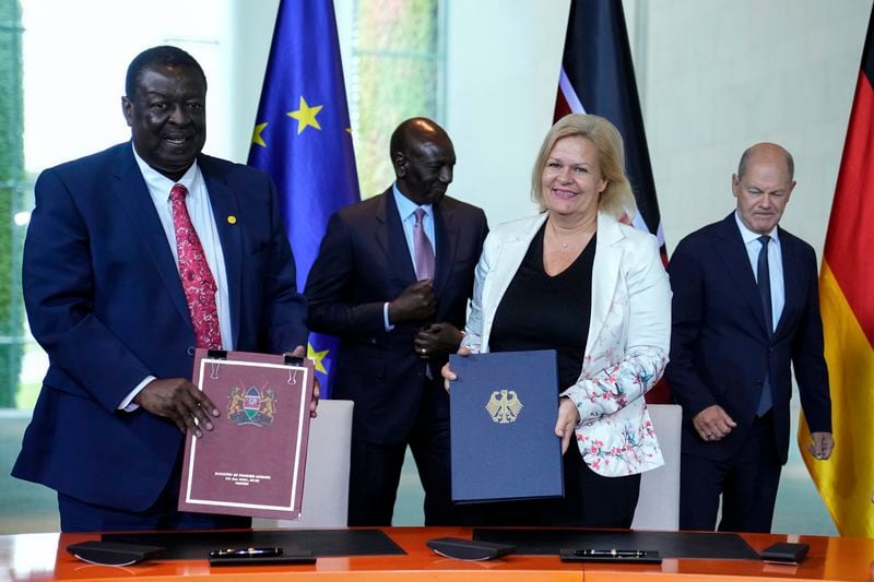 German Interior Minister Nancy Faeser, second from right, and Kenyan's Prime Cabinet Secretary Musalia Mudavadi, left, pose for a photo after signing a migration agreement at the chancellery in Berlin, Friday, Sept. 13, 2024. Behind them are German Chancellor Olaf Scholz, right, and Kenyan President William Ruto. (AP Photo/Ebrahim Noroozi)